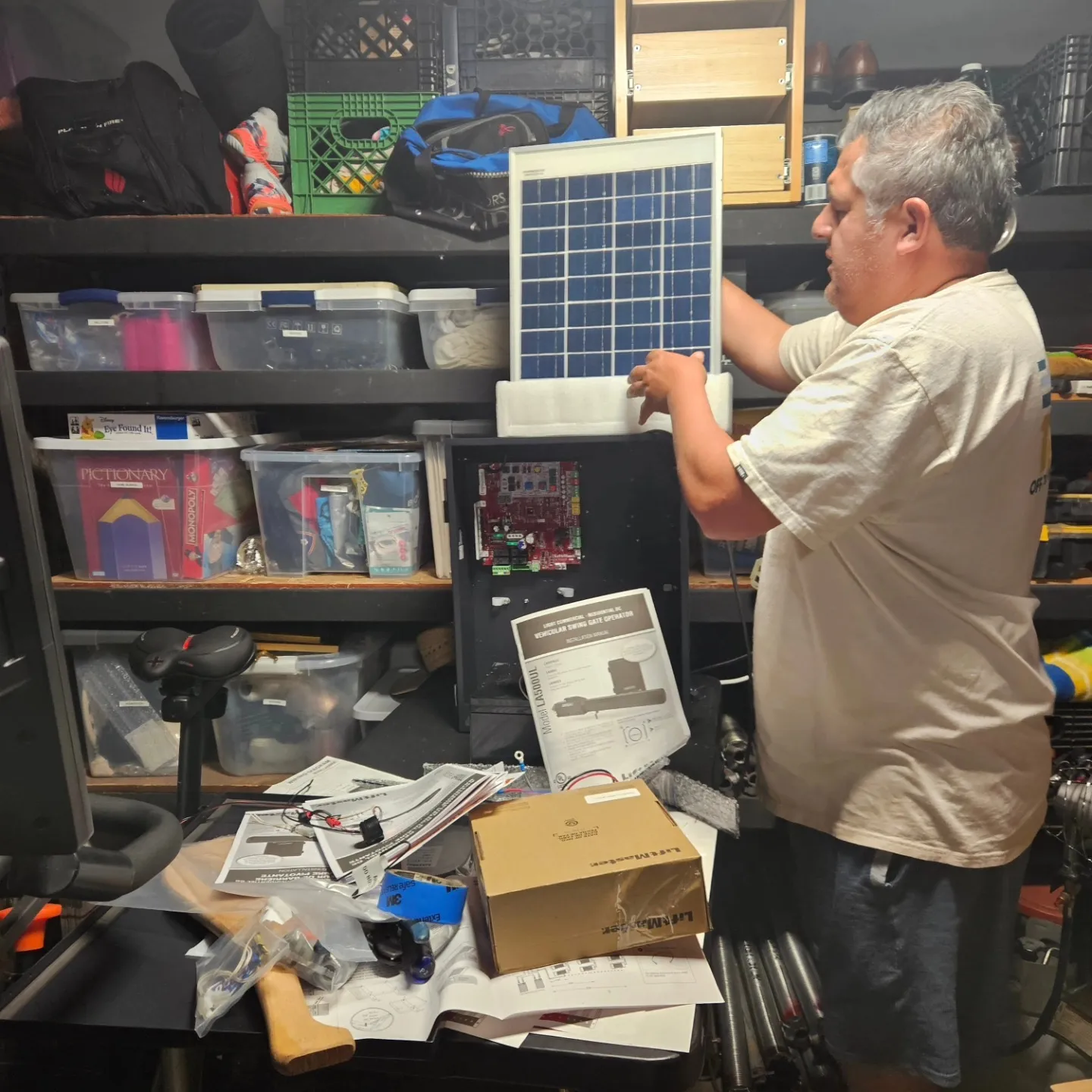 John from Republic Doors and Gates setting up a solar gate opener in the shop